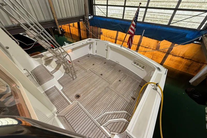 Slide: The Image of 2000 Grand Banks 43 Eastbay FB yacht deck with ladder and American flag in marina. - 39