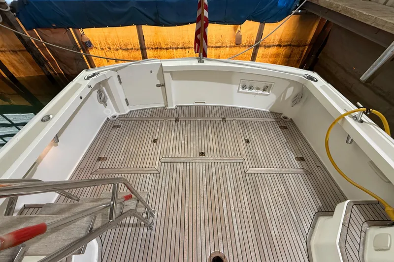 Slide: The Image of Teak deck of 2000 Grand Banks 43 Eastbay FB yacht, featuring clean lines and marine equipment. - 41