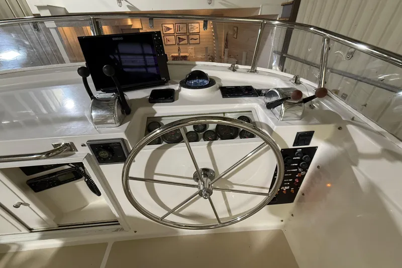 Slide: The Image of Helm of 2000 Grand Banks 43 Eastbay FB with steering wheel and navigation controls. - 49
