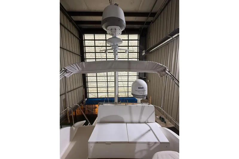 Slide: The Image of 2000 Grand Banks 43 Eastbay FB yacht in storage, featuring radar and satellite equipment. - 52