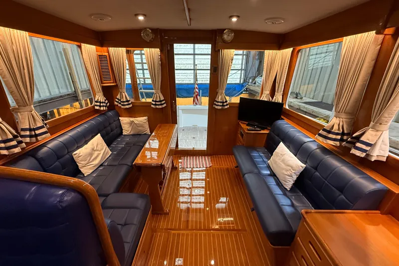 Slide: The Image of Luxurious interior of 2000 Grand Banks 43 Eastbay FB yacht with elegant seating and wood finishes. - 58
