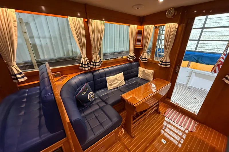 Slide: The Image of Luxurious interior of 2000 Grand Banks 43 Eastbay FB with blue leather seating and wooden accents. - 59