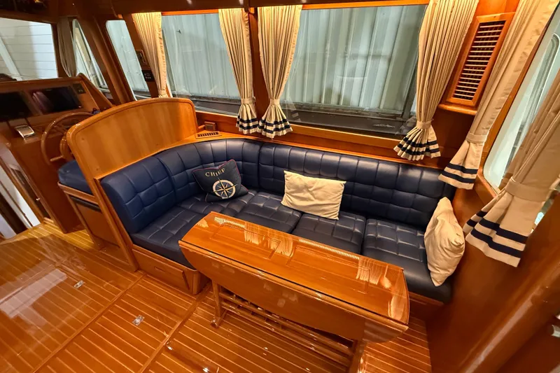 Slide: The Image of Luxurious interior of 2000 Grand Banks 43 Eastbay FB with blue leather seating and wooden accents. - 60