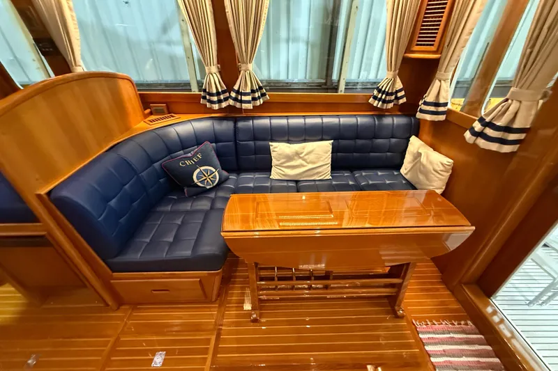 Slide: The Image of Luxurious interior of 2000 Grand Banks 43 Eastbay FB with blue leather seating and wooden table. - 61