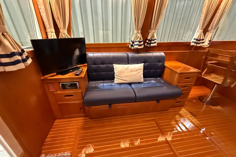 Slide: The Image of Luxurious interior of 2000 Grand Banks 43 Eastbay FB with sofa, TV, and wooden furnishings. - 63