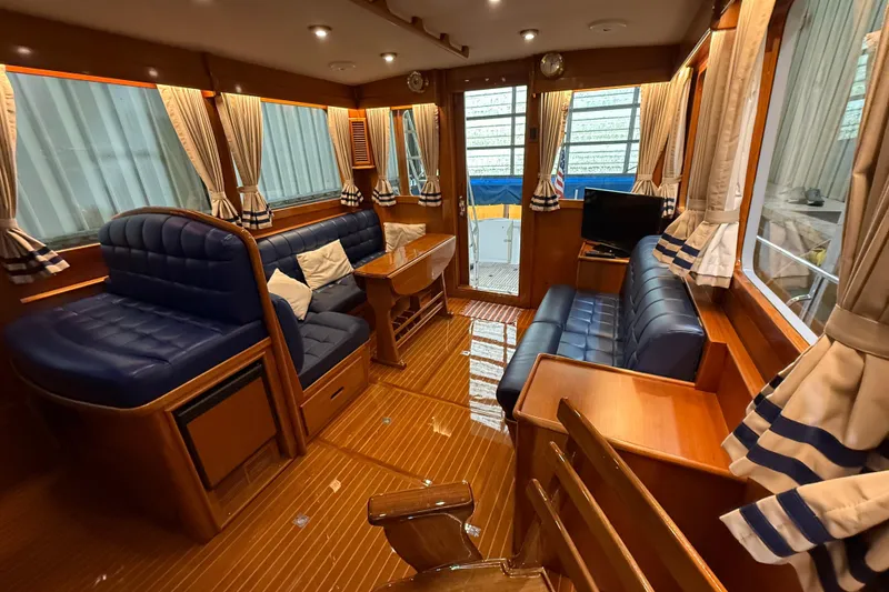 Slide: The Image of Luxurious interior of 2000 Grand Banks 43 Eastbay FB yacht with blue seating and wood finishes. - 65