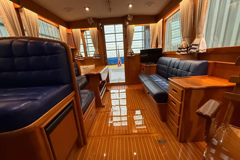Slide: The Image of Luxurious interior of 2000 Grand Banks 43 Eastbay FB yacht with polished wood and blue seating. - 66