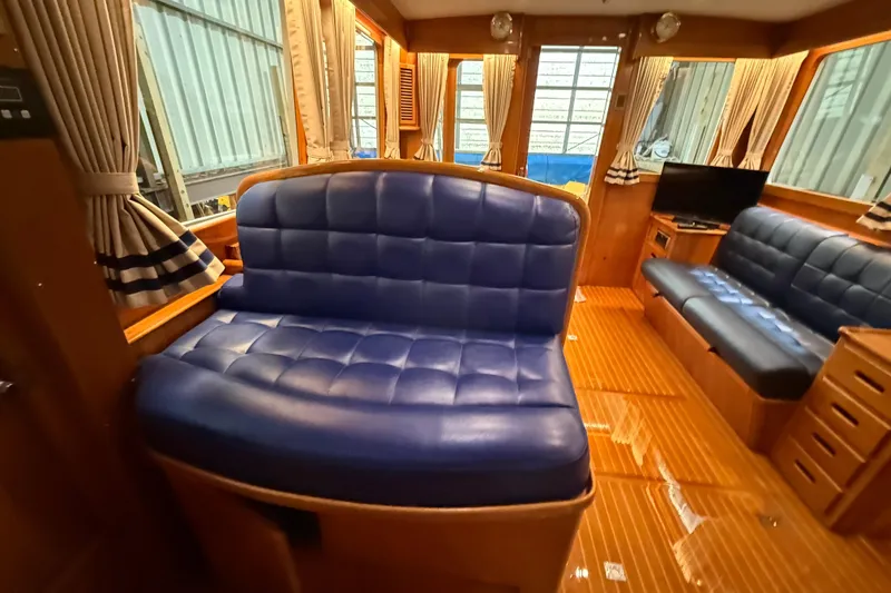 Slide: The Image of Luxurious interior of 2000 Grand Banks 43 Eastbay FB with blue leather seating and wood finish. - 72