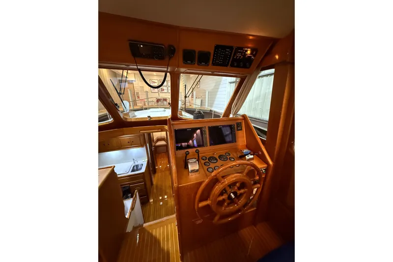 Slide: The Image of Interior helm of 2000 Grand Banks 43 Eastbay FB with wooden steering wheel and navigation instruments. - 73