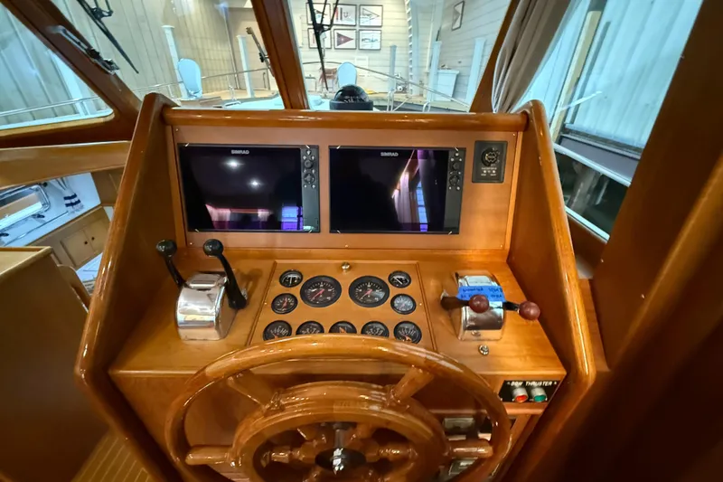 Slide: The Image of Helm of 2000 Grand Banks 43 Eastbay FB with wooden wheel and navigation instruments. - 75