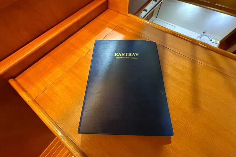 Slide: The Image of Blue Eastbay manual on wooden surface, Grand Banks 43 Eastbay FB, 2000 model. - 86