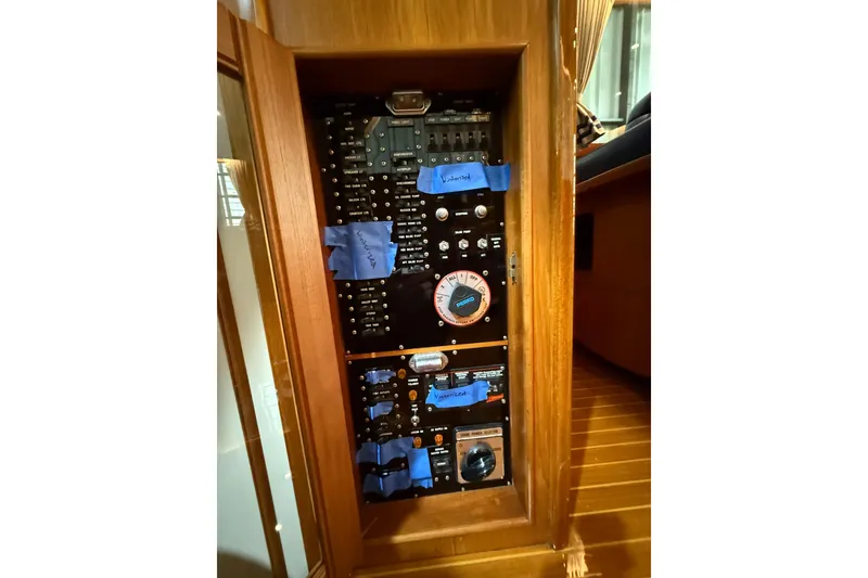 Slide: The Image of Electrical panel inside 2000 Grand Banks 43 Eastbay FB yacht, featuring labeled switches and controls. - 89