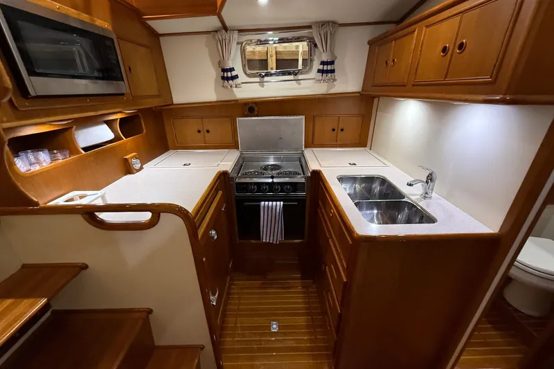 Slide: The Image of Luxurious 2000 Grand Banks 43 Eastbay FB yacht kitchen with wood cabinetry and modern appliances. - 92