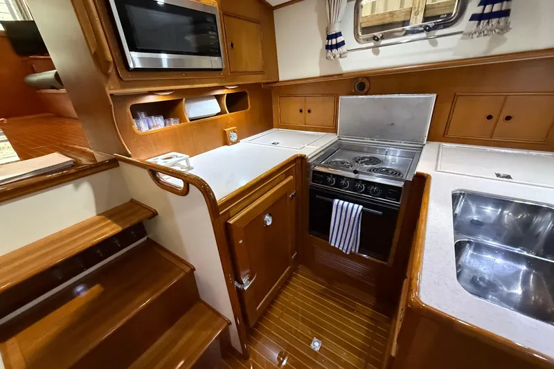 Slide: The Image of Galley kitchen in 2000 Grand Banks 43 Eastbay FB yacht with stove, microwave, and sink. - 94