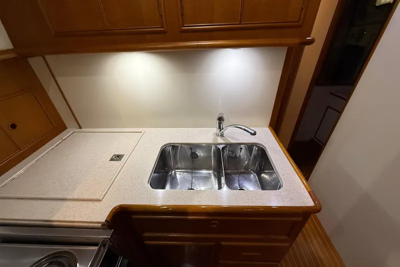 Slide: The Image of Galley sink area in 2000 Grand Banks 43 Eastbay FB yacht, featuring dual stainless steel basins. - 95