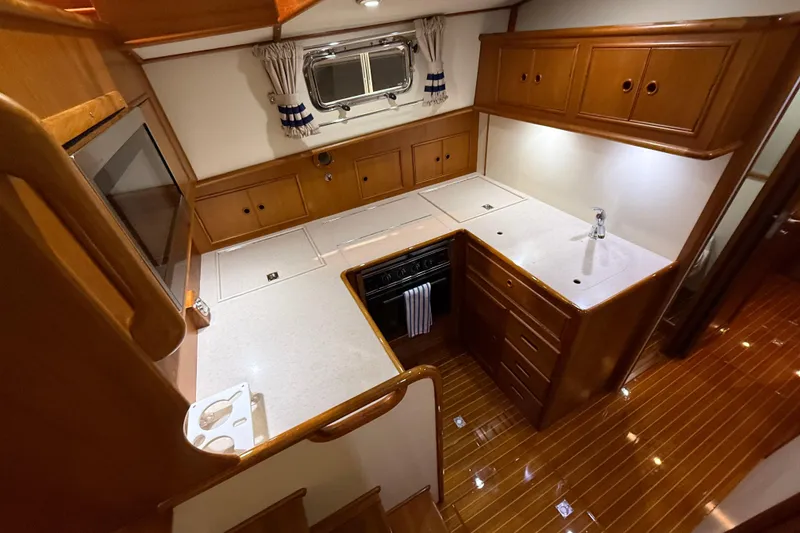 Slide: The Image of Luxurious kitchen interior of 2000 Grand Banks 43 Eastbay FB yacht with wooden cabinetry. - 98