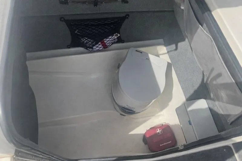 Slide: The Image of Interior of 1997 Sea Ray 240 Sundeck with portable toilet. - 4