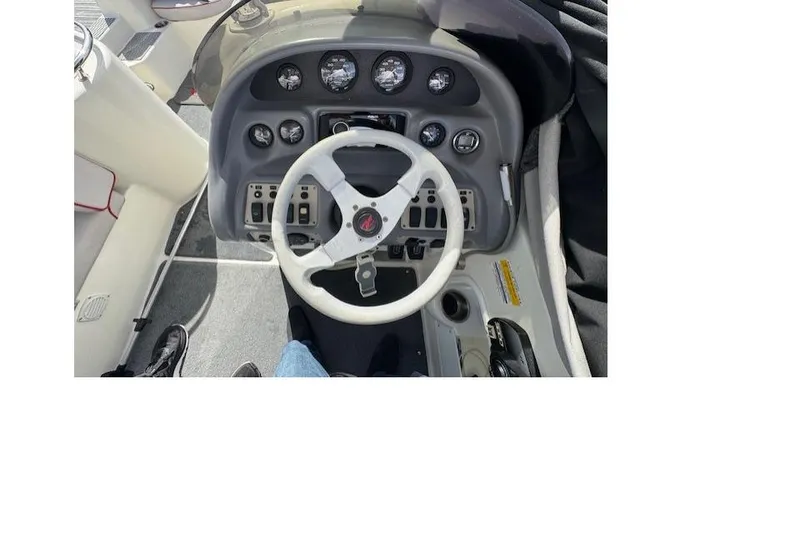 Slide: The Image of 1997 Sea Ray 240 Sundeck dashboard with steering wheel and instrument panel. - 5