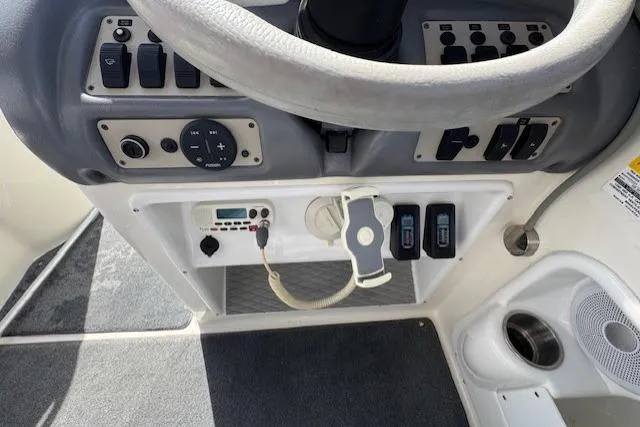Slide: The Image of Control panel of a 1997 Sea Ray 240 Sundeck boat, featuring steering wheel and switches. - 6