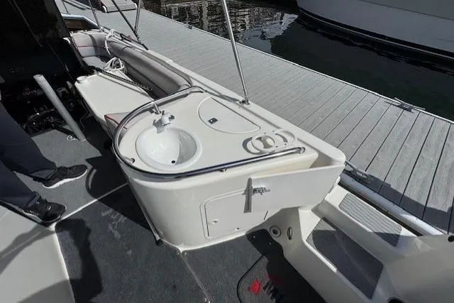 Slide: The Image of 1997 Sea Ray 240 Sundeck boat interior with sink and seating area. - 7