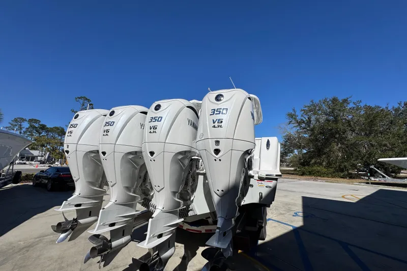 Slide: The Image of Four Yamaha 350 V6 outboard engines on a 2027 Caymas 401 CC boat under clear blue sky. - 11