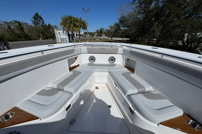 Slide: The Image of 2027 Caymas 401 CC boat interior with cushioned seating and modern design. - 16