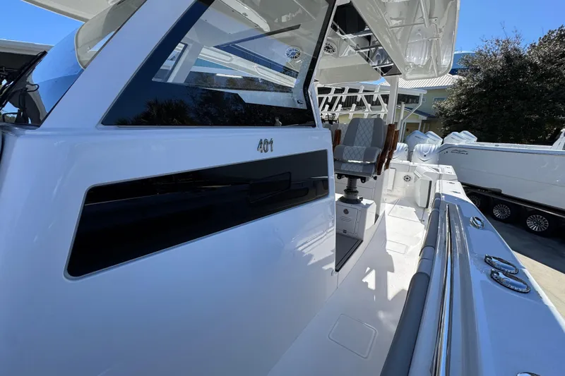 Slide: The Image of 2027 Caymas 401 CC boat, sleek design, modern seating, and spacious deck. - 22