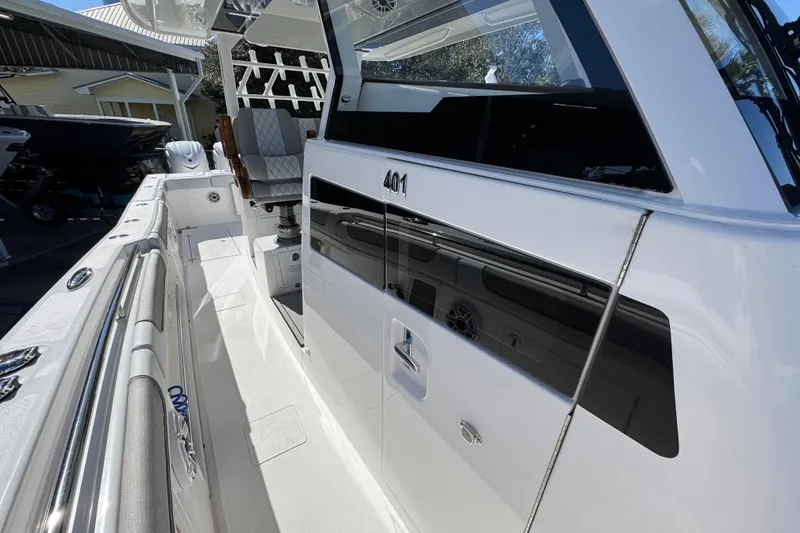 Slide: The Image of 2027 Caymas 401 CC boat side view with sleek design and modern features. - 23