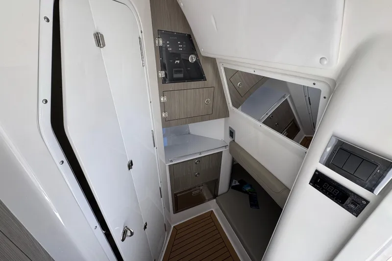 Slide: The Image of Interior of 2027 Caymas 401 CC boat featuring modern cabinetry and control panel. - 24