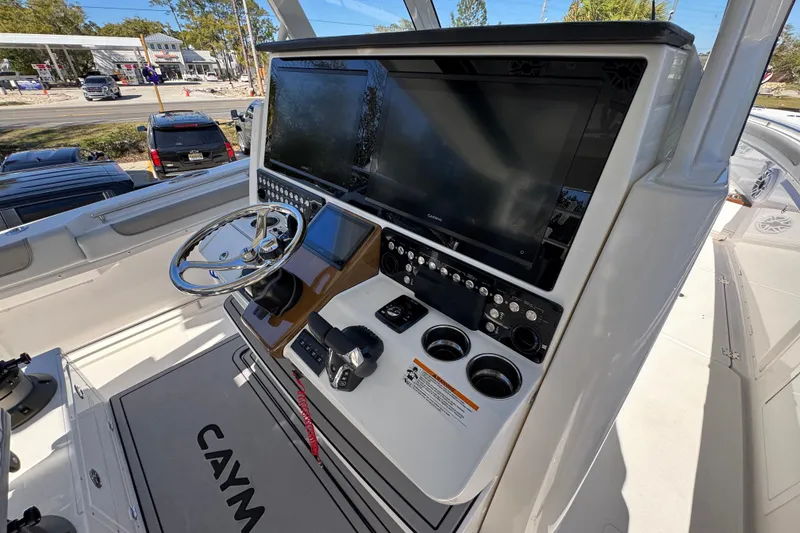 Slide: The Image of 2027 Caymas 401 CC boat helm with advanced navigation displays and controls. - 40