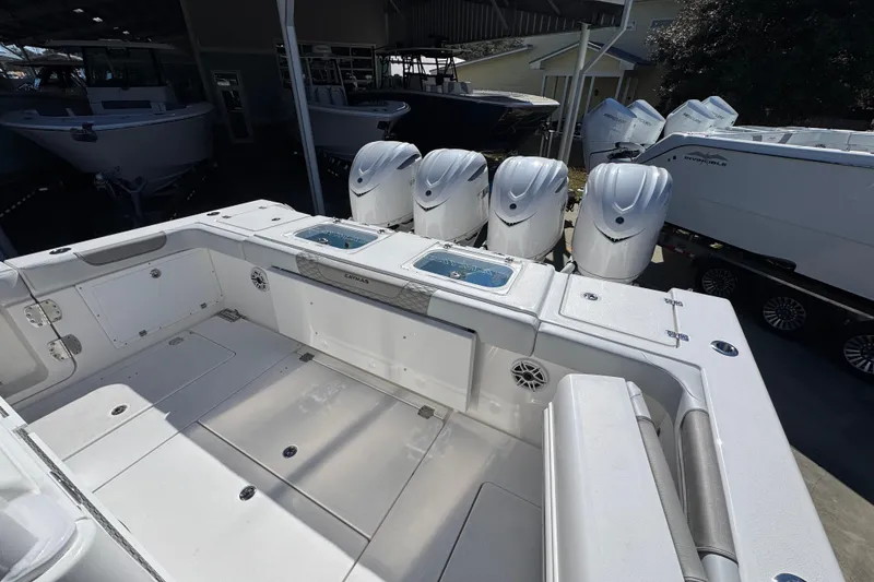 Slide: The Image of 2027 Caymas 401 CC boat with multiple outboard engines in a showroom. - 48