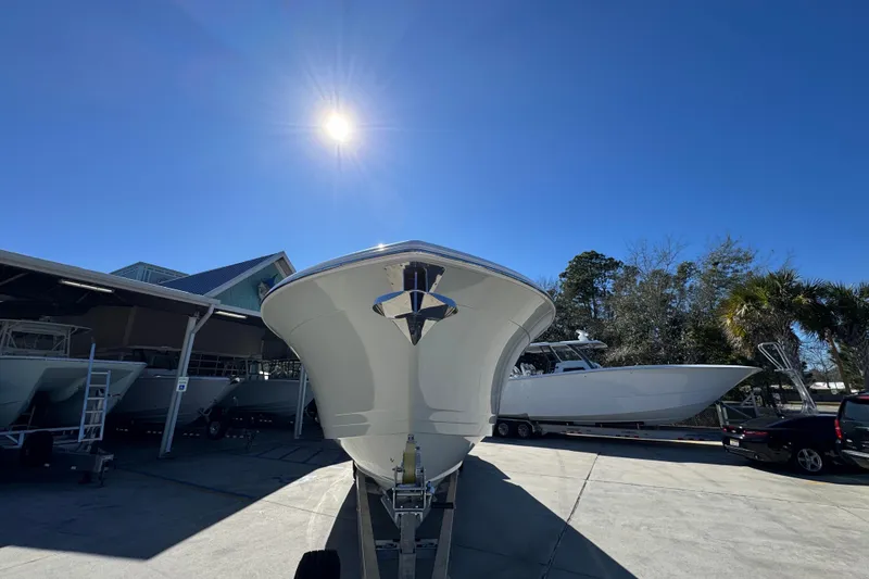 Slide: The Image of 2027 Caymas 401 CC boat under bright sun in a marina setting. - 5