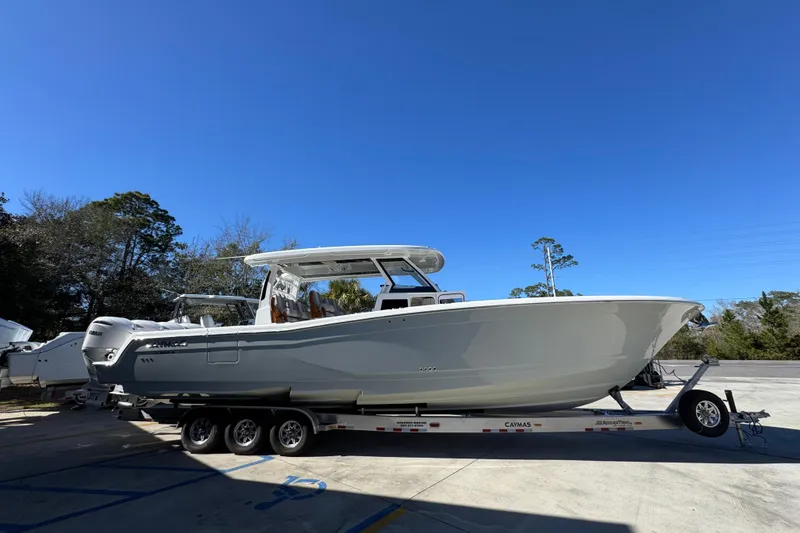 Slide: The Image of 2027 Caymas 401 CC boat on trailer under clear blue sky. - 8