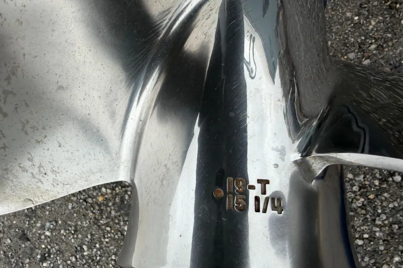 Slide: The Image of Close-up of a polished metal boat propeller with engraved specifications, Skeeter SX241 2025. - 10