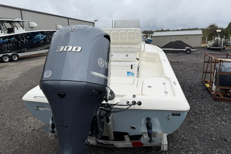 Slide: The Image of 2025 Skeeter SX241 boat with Yamaha 300 engine, parked outdoors. - 12