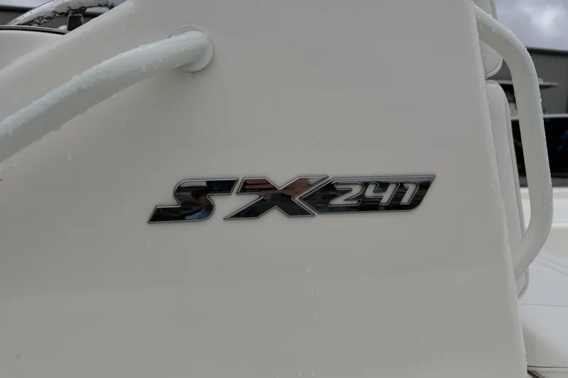 Slide: The Image of 2025 Skeeter SX241 boat logo on white surface, close-up view. - 13