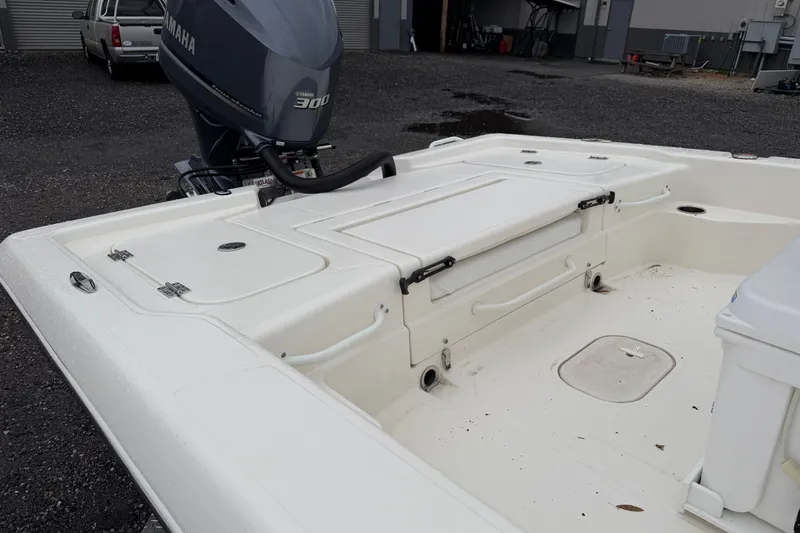 Slide: The Image of 2025 Skeeter SX241 boat with Yamaha 300 engine, white deck, outdoor setting. - 15