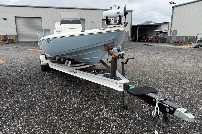 Slide: The Image of 2025 Skeeter SX241 boat on trailer in industrial parking lot. - 20