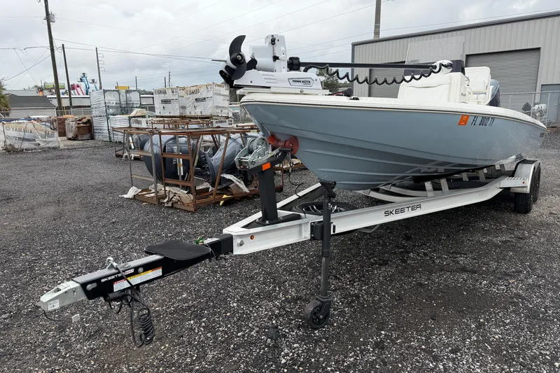 Slide: The Image of 2025 Skeeter SX241 boat on trailer in outdoor storage area. - 21