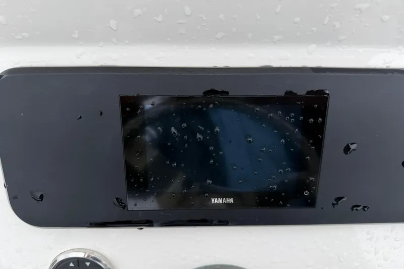 Slide: The Image of Yamaha display on 2025 Skeeter SX241 boat, wet with raindrops. - 39