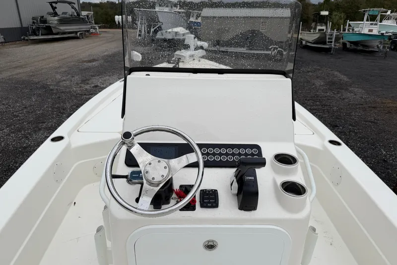 Slide: The Image of 2025 Skeeter SX241 boat helm with steering wheel and controls. - 45