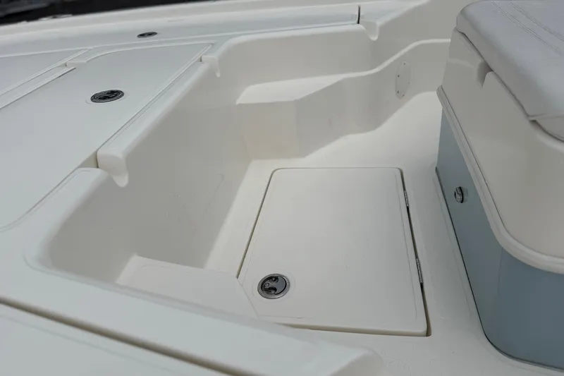 Slide: The Image of 2025 Skeeter SX241 boat interior with storage compartments and seating area. - 51