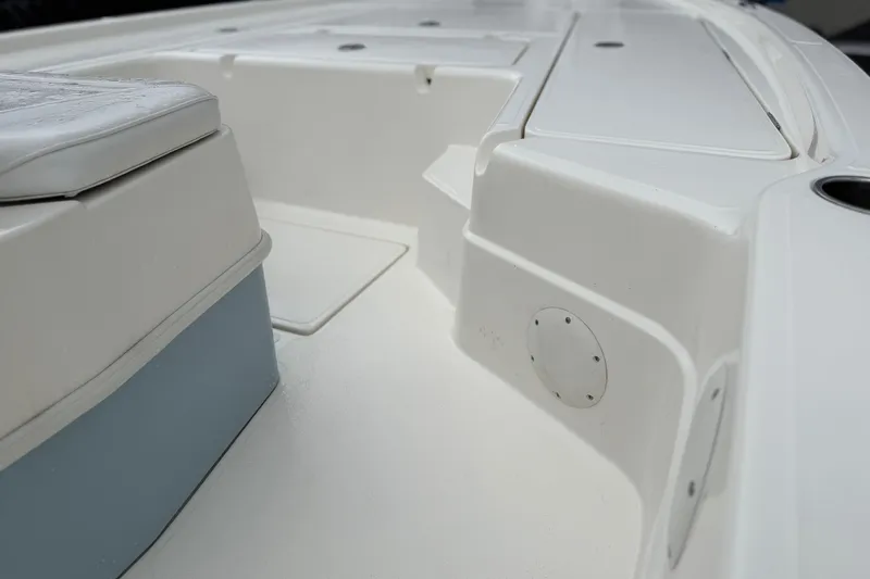 Slide: The Image of 2025 Skeeter SX241 boat interior, featuring white seating and storage compartments. - 53
