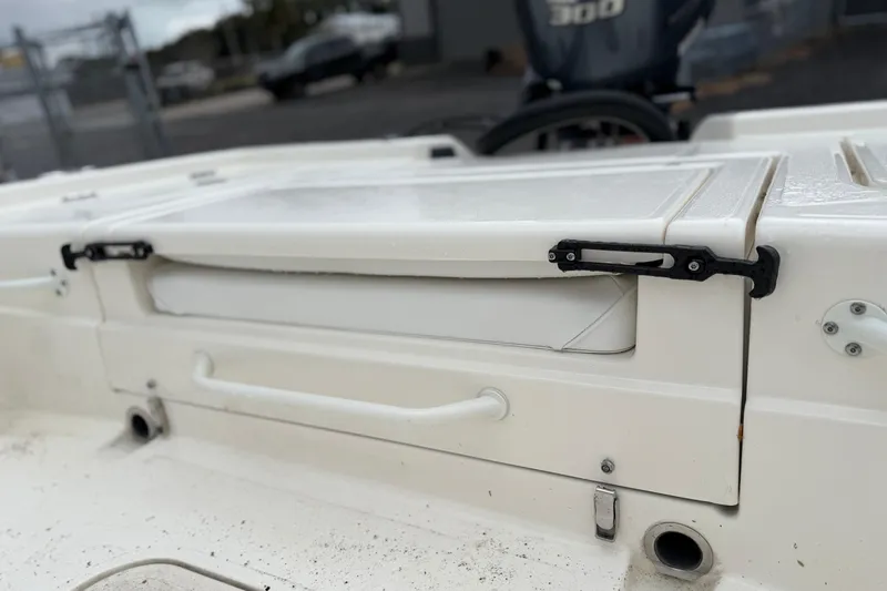 Slide: The Image of 2025 Skeeter SX241 boat deck with storage compartment and latch detail. - 58