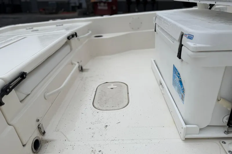 Slide: The Image of Interior of 2025 Skeeter SX241 boat with storage compartments and cooler. - 62