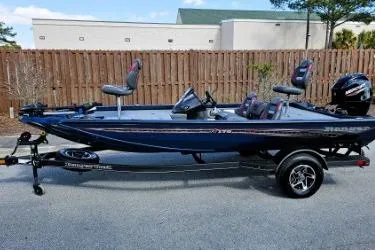 Slide: The Image of 2022 Ranger RT178 fishing boat on trailer, side view, parked outdoors. - 1