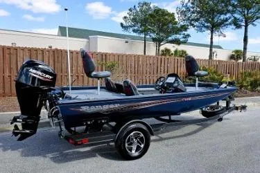 Slide: The Image of 2022 Ranger RT178 fishing boat with Mercury engine, parked outdoors. - 11