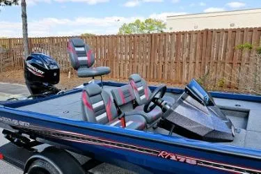 Slide: The Image of 2022 Ranger RT178 boat with seating and Mercury outboard motor, parked outdoors. - 5