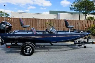 Slide: The Image of 2022 Ranger RT178 boat with trailer, parked outdoors on a sunny day. - 7