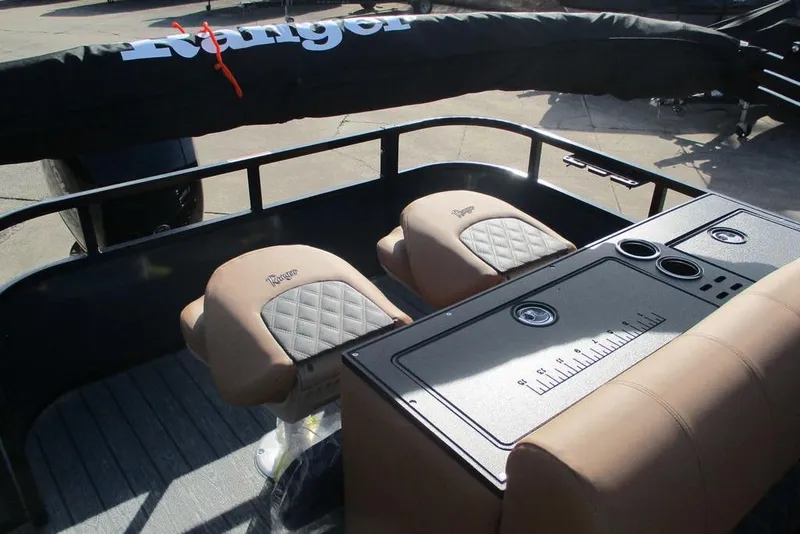 Slide: The Image of 2026 Ranger 220FC boat interior with tan seats and fishing station. - 11